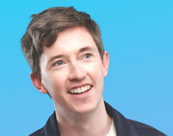 Jake Lambert laughing with the audience during a guest appearance with The League of Improv