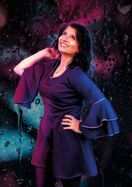 Shaparak Khorsandi smiling during a guest appearance with The League of Improv